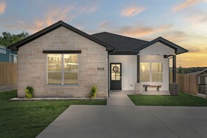 Stunning two-story residence with a beautifully manicured lawn and a welcoming entrance.