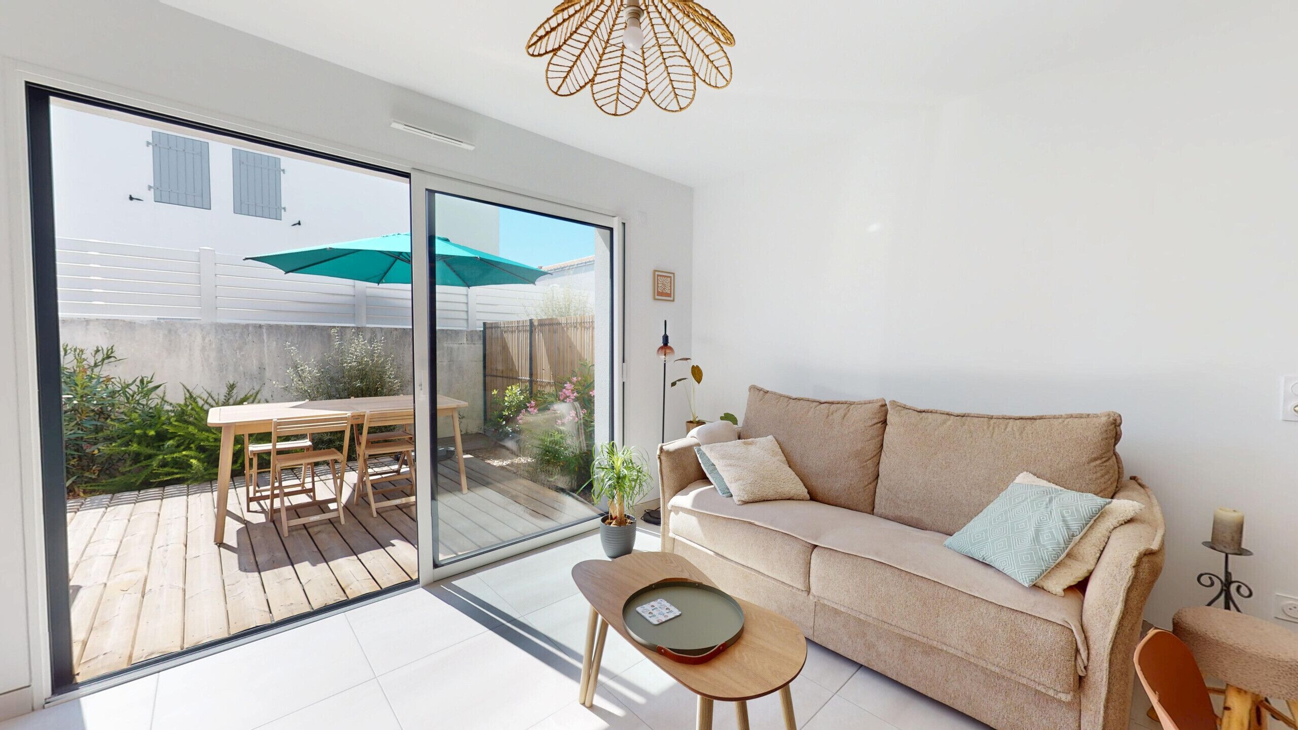 A modern living room with a sliding glass door leading to a patio area.