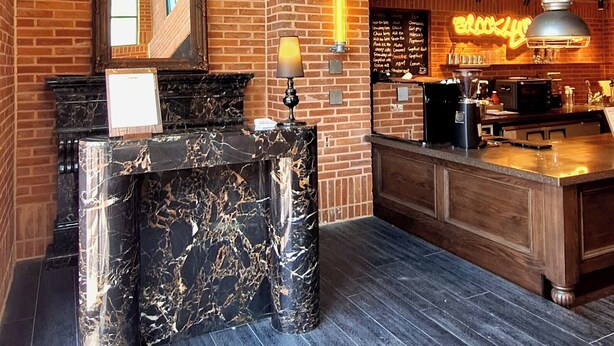 A modern interior with brick walls, large windows, and a bar area. - Brooklyn Blues (Seoul)