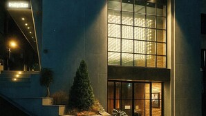 A modern building with a glass facade and a sign reading "Brooklyn Blues". - Brooklyn Blues (Seoul)