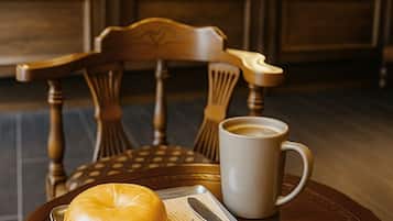 A dining table with a bagel, a sandwich, and a coffee cup, with a neon sign reading "Brooklyn Blues" in the background.