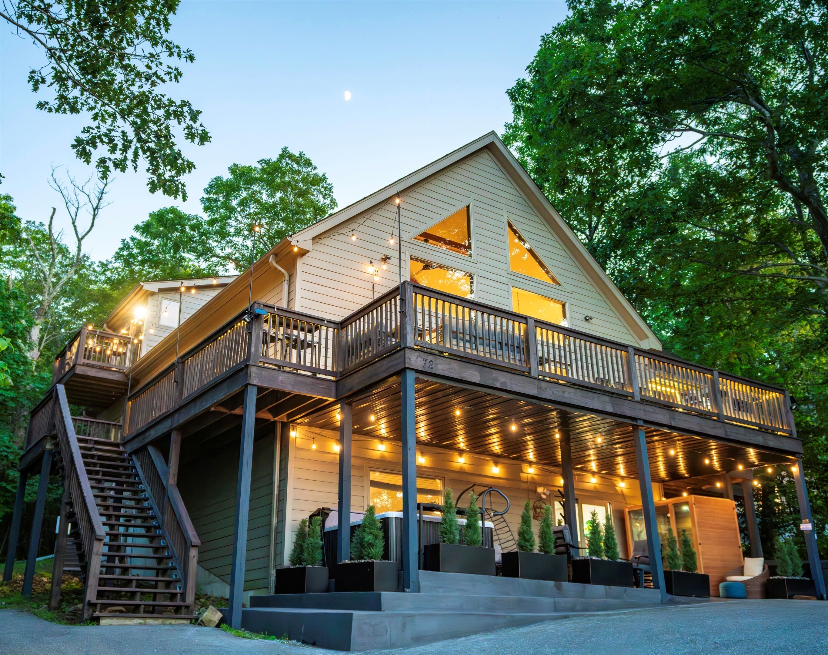 A two-story house with a balcony and a covered porch area.