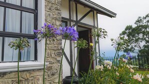 A stone cottage with a sign reading "The Dover Cottage." - Dover Cottage (Nuwara Eliya)