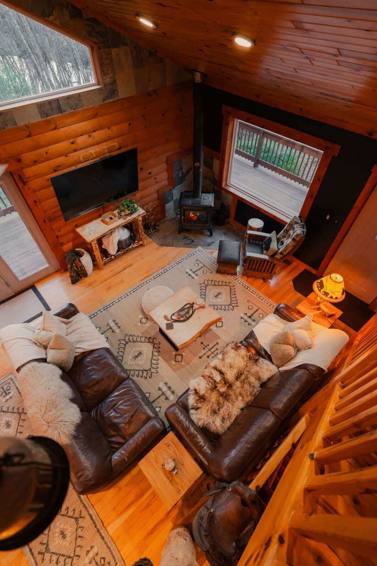 Living Room: Bright, airy space with leather couches and rustic charm—perfect for relaxation!