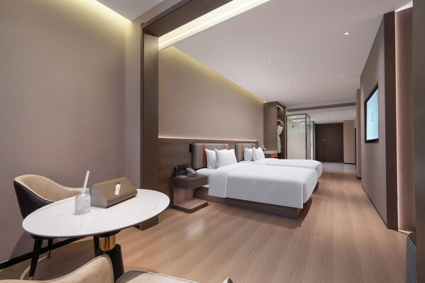 A modern hotel room with a bed, bedside table, chair, and a desk with a laptop. - World Hotel Hualian Shoppin Plaza branch (Kaifeng)