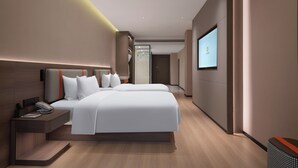 A modern hotel room with a large bed, bedside tables, a TV, and a wooden floor. - World Hotel Hualian Shoppin Plaza branch (Kaifeng)
