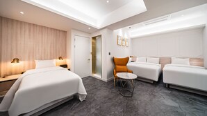A modern hotel room with two beds, a small round table, and a chair. - Insta Hotel - Main Branch (Suwon)