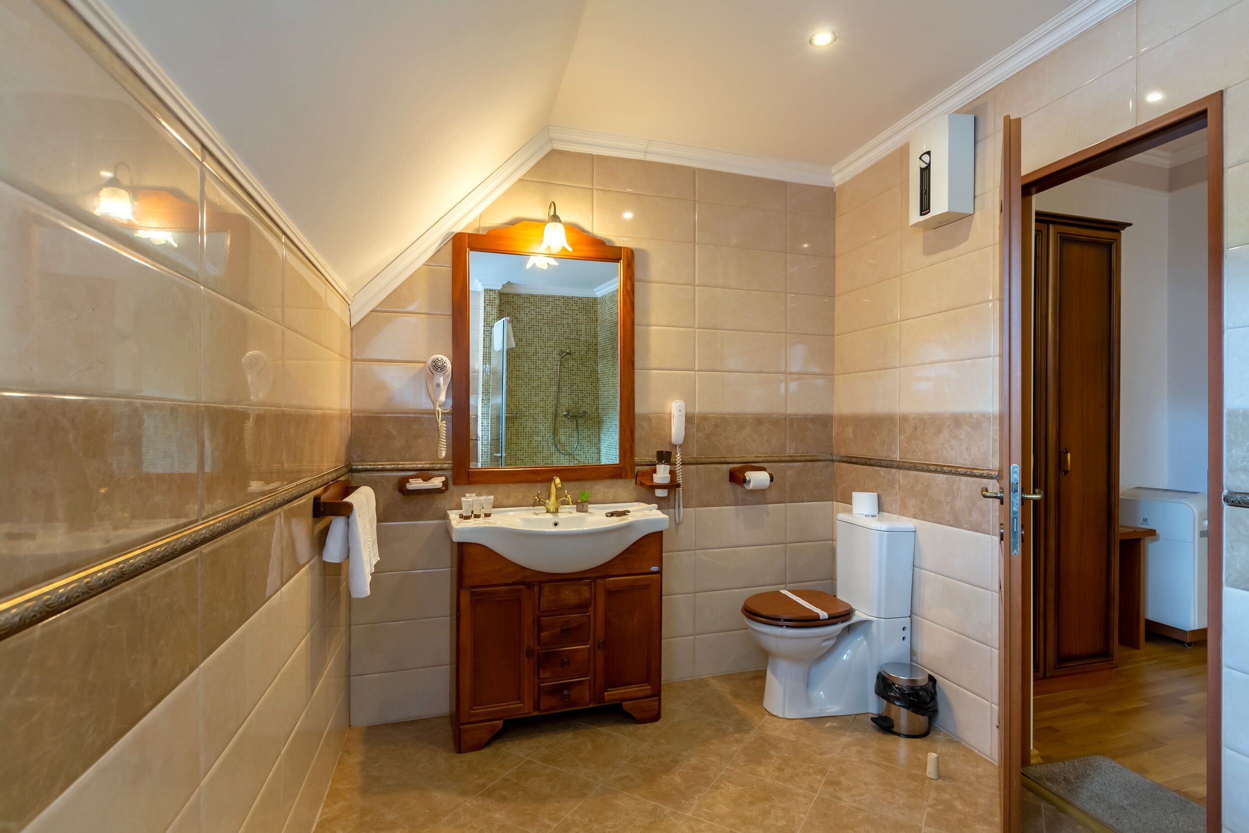 A modern bathroom with a vanity, sink, mirror, and toilet.