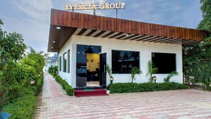 A modern building with a sign reading "EVENCIA GROUP" at the entrance. - Evencia Resort (Ramnagar)