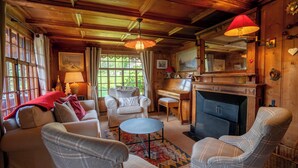 A cozy living room with a fireplace, wooden ceiling, and comfortable seating. - This beautiful chalet built in 1872 is located in the heart of the pretty village of Gryon. Gryon tr (Gryon)