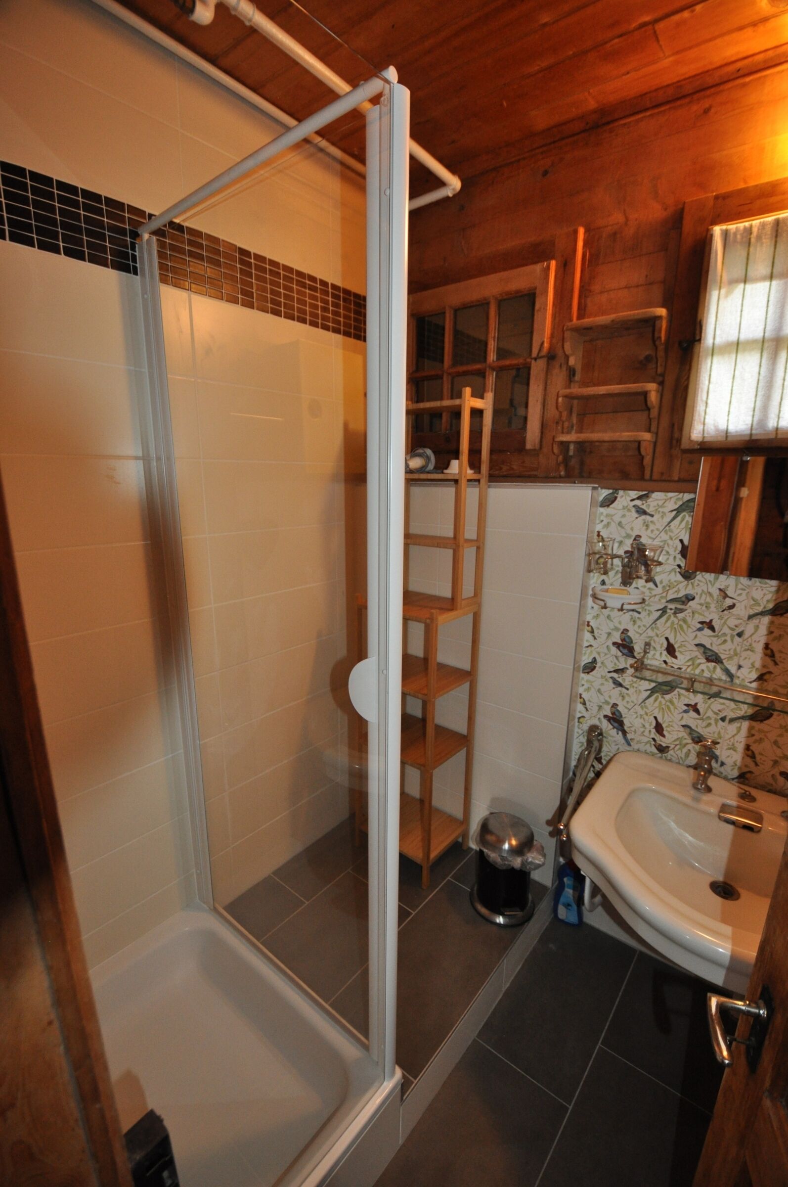 A bathroom with a shower, a sink, and a toilet.