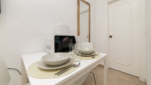 A clean, white bathroom with a microwave, a sink, and a mirror. - Classy IX - Ferga Suites (Madrid)