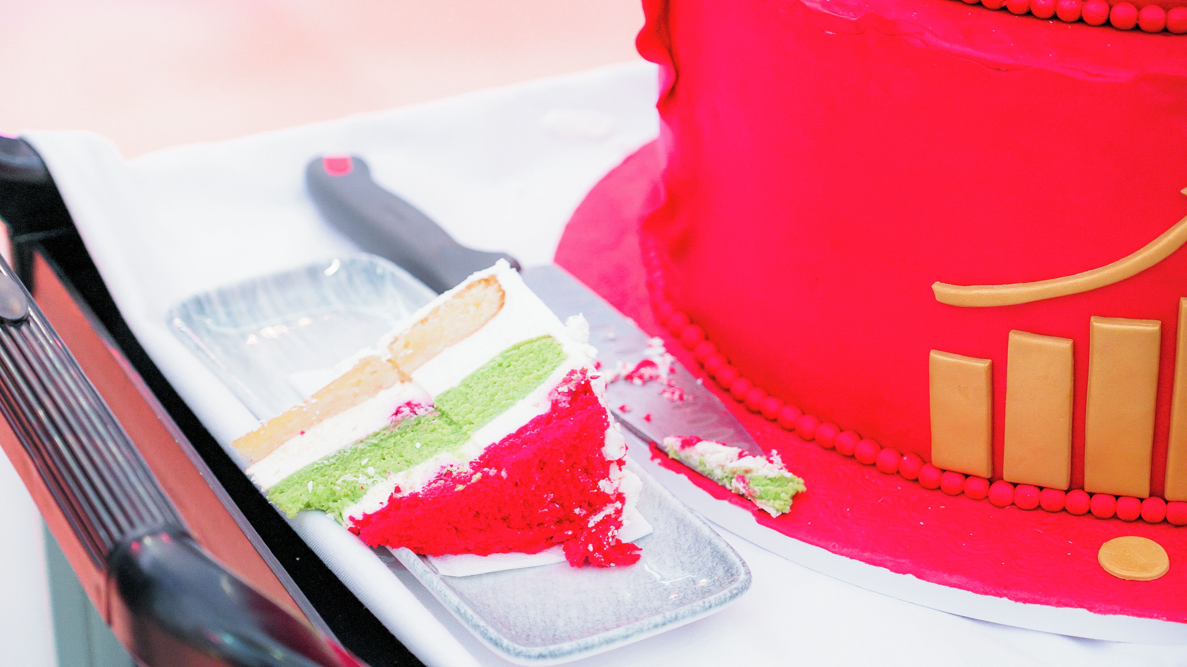 A cake with multiple layers and a knife on a plate.