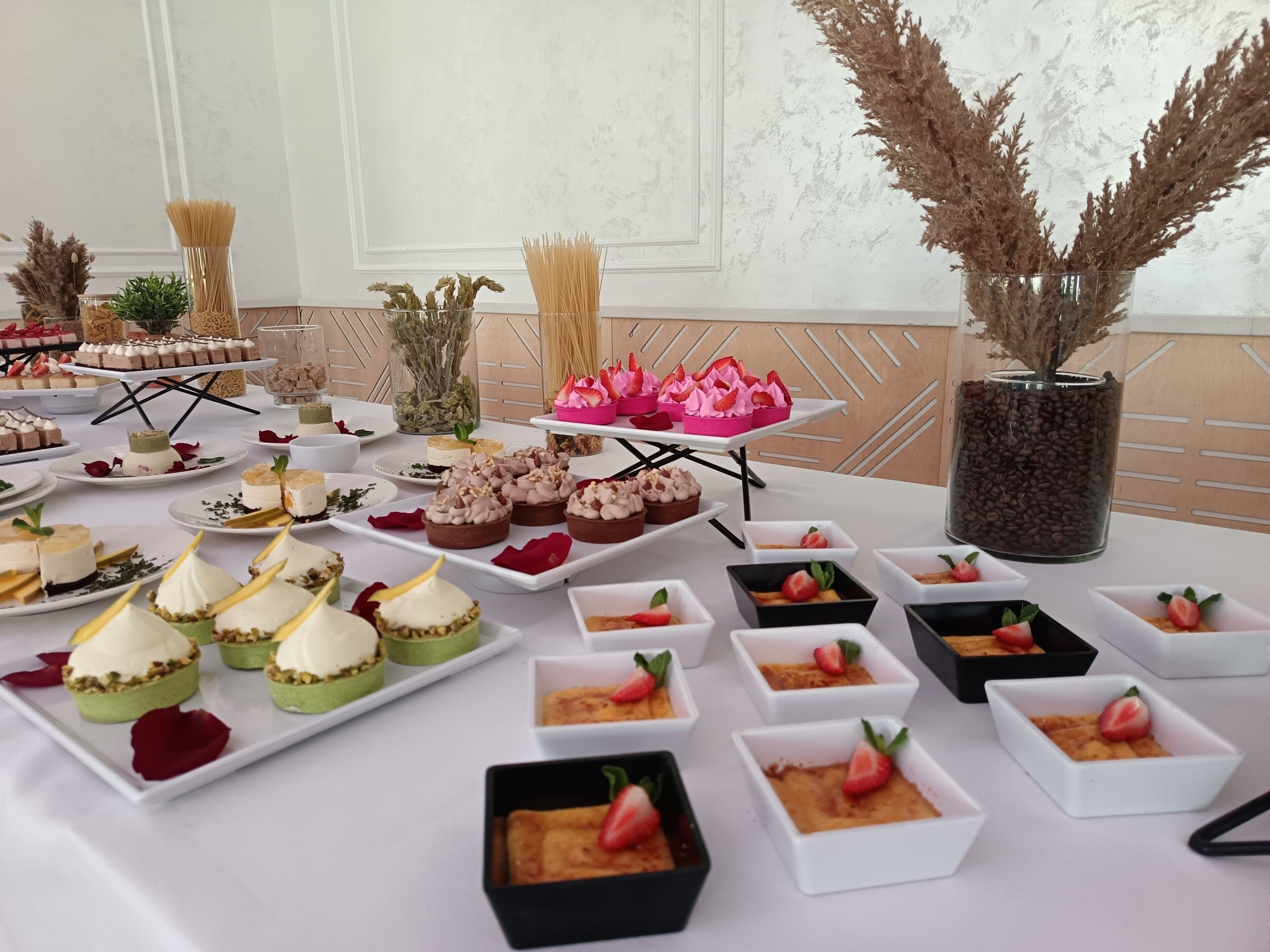 A buffet table with various desserts and snacks.