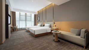 A modern hotel room with a large bed, a sofa, a desk, and a TV. - World Hotel Qingxian County Cangzhou (Cangzhou)