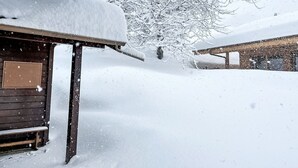 A wooden cabin with a snow-covered roof and a bench outside. - Stunning private villa for 6 guests with WIFI, TV and terrace (Les Vérines (chamoson))