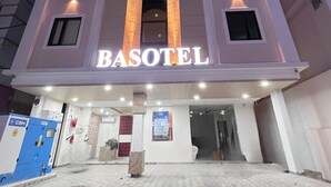 A hotel named BASOTEL with a prominent entrance, a central archway, and multiple windows. - Basotel Hotel Indore (Indore)