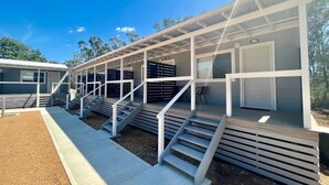 A modern building with a covered outdoor area, multiple staircases, and a visible room number. - Westview Caravan Park - Dubbo (Dubbo)