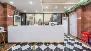 A reception area with a check-in counter, air conditioning units, and a check-in desk.