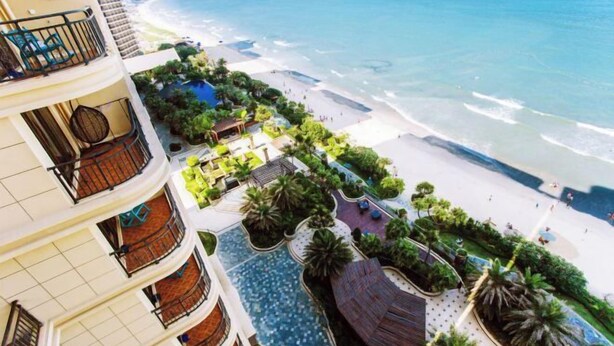 A hotel with multiple balconies, a pool area, and a beach view. - Bao'an Rainbow Bay Hotel (Huidong)