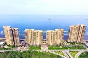 Un complejo residencial de edificios altos con varios edificios de apartamentos, una red de carreteras y vistas al mar.