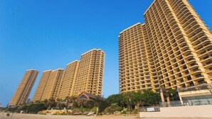 A high-rise residential building with multiple balconies, a flat roof, and a clear blue sky in the background. - Bao'an Rainbow Bay Hotel (Huidong)