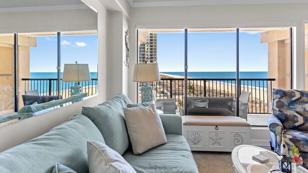 A balcony with a view of the beach and ocean. - Bright Oceanfront Studio | Sleeps 4 w/ Pool Access (Ocean City)