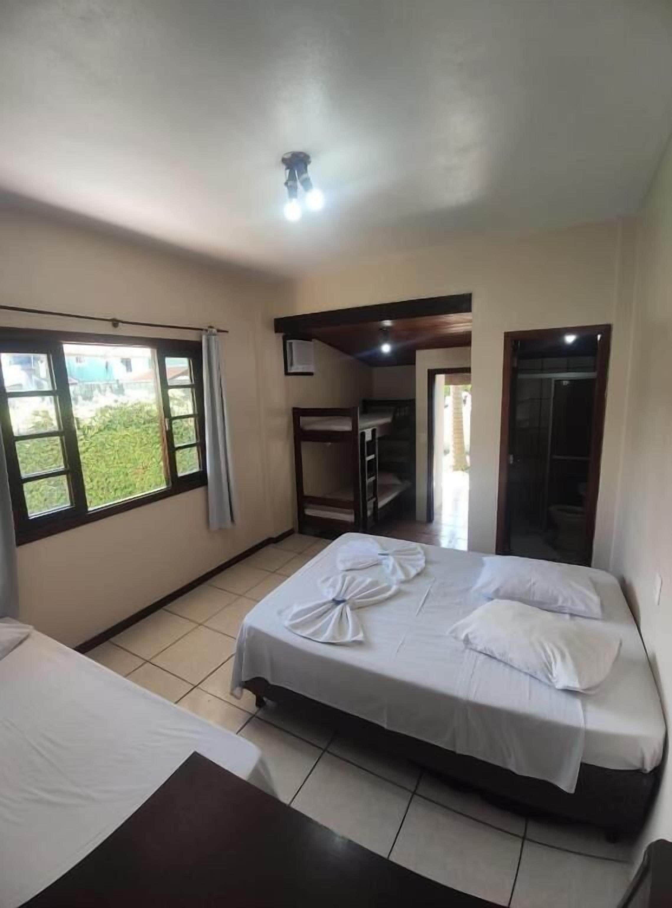 Una camera d'albergo con un letto, una scrivania, una finestra e vista sull'esterno.