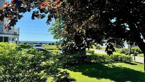 A residential area with a house, a lawn, and a parked car. - Ocean Views! Walk to Beaches! 4BR Vacation Retreat (Kennebunk)