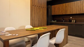 A modern kitchen with wooden cabinets, a stainless steel refrigerator, and a black countertop. - Dioroh Suites Meteora 304 (Kalabaka)
