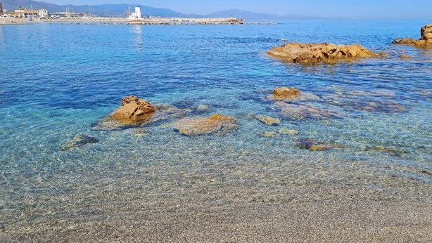 A coastal scene with clear water, rocky formations, and distant buildings. - 🌴 **Luxury Coastal Getaway – 2 Bed, 2 Bath Apartment with Pool Views** 🌴
 (Manilva)