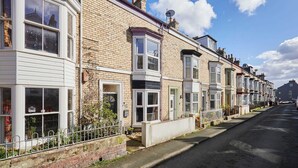 A row of terraced houses with white window frames and brick facades. - Host Stay Gray Street (Whitby)