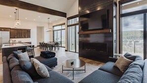 A modern living room with a large sofa set, a coffee table, and a fireplace. - Luxury Listing | A/C, Hot Tub, Close to Skiing, Incredible Mountain Views (Pagosa Springs)