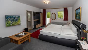 Relax in a stylish room with a large bed, comfortable seating area, and a beautiful view of the outdoors.