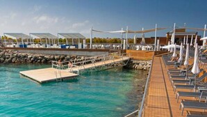 A deck with sun loungers and a poolside area. - Holiday Home in Spain Near the Beach & Marina (San Bartolomé de Tirajana)