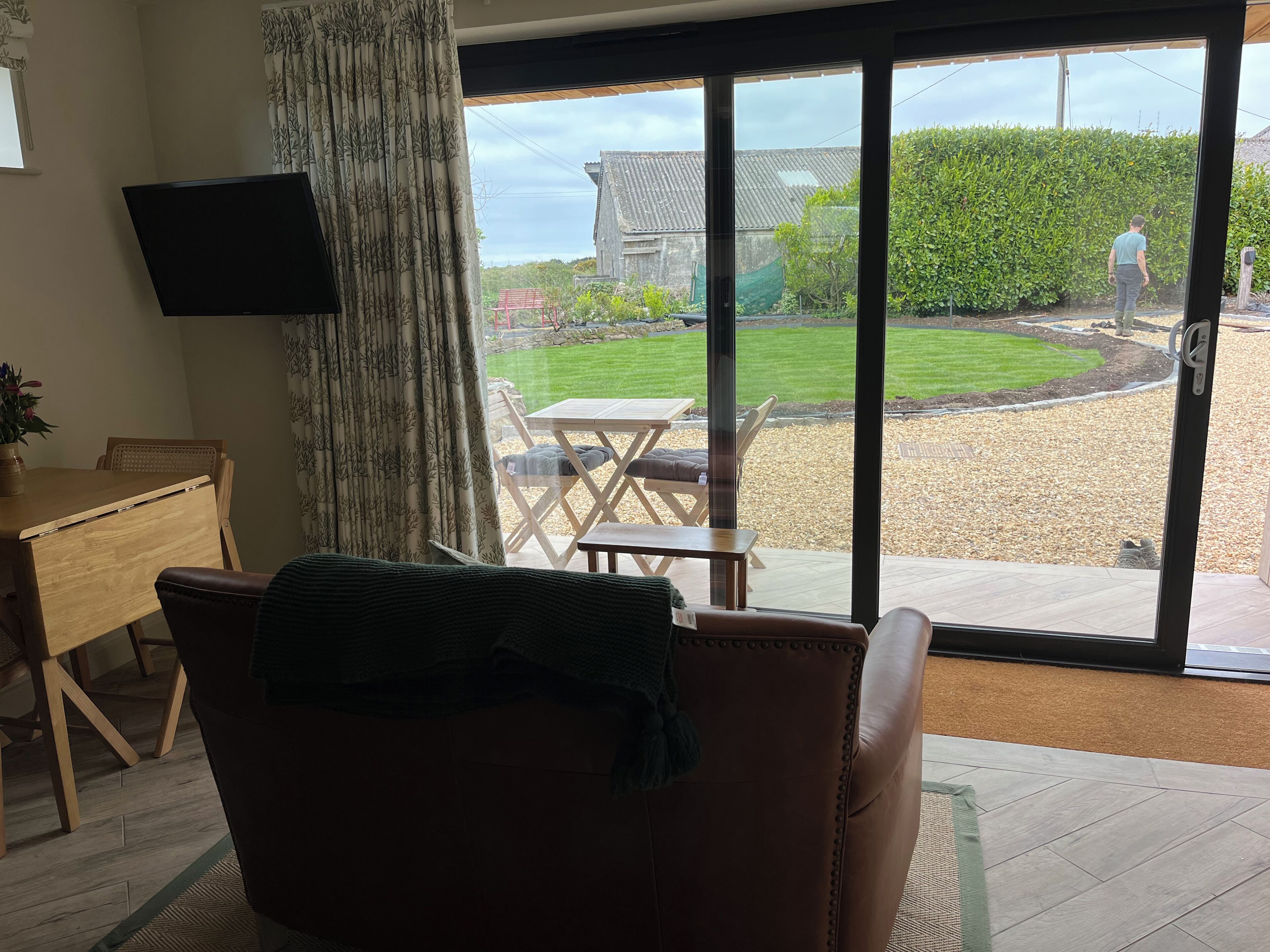 A living room with a large sliding glass door leading to a patio.