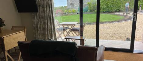 A living room with a large sliding glass door leading to a patio.