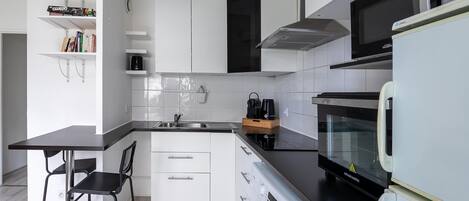 Fridge, microwave, coffee/tea maker, cookware/dishes/utensils