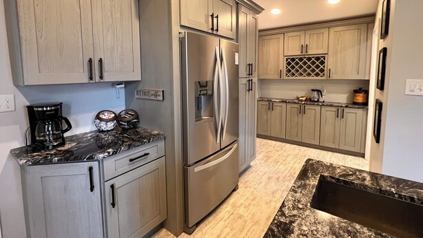 A modern kitchen with light wood cabinets, stainless steel appliances, and a marble countertop. - The Vintage on Market, w/Pool, near Hershey, Ironstone Ranch & Spooky Nook (Elizabethtown)
