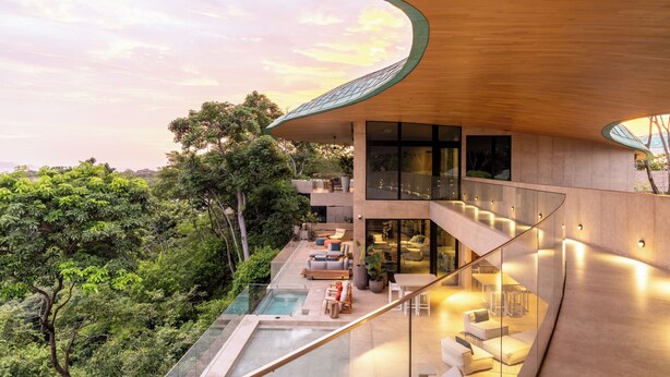 A modern building with a glass staircase, outdoor seating, and a pool. - Villa Mariposa - Brand New - 7 Bedroom 8.5 Bath - Peninsula Papagayo (Peninsula Papagayo)