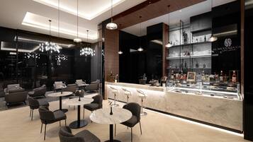 A modern bar area with marble countertops and a variety of liquor bottles.