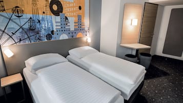 A hotel room with two beds, a wall mural, a nightstand, a bedside table, a mirror, and a door.