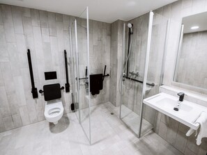 A modern bathroom with a glass-enclosed shower, a white sink, and a toilet. - B&B HOTEL Wien-Heilligenstadt (Vienna)