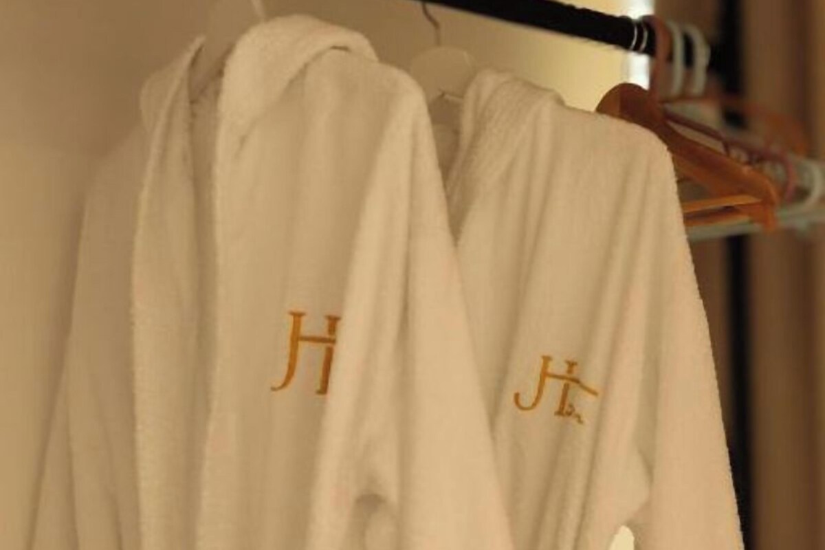 A rack with white robes hanging on it.