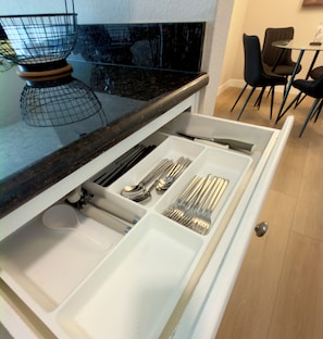 A kitchen drawer with utensils.