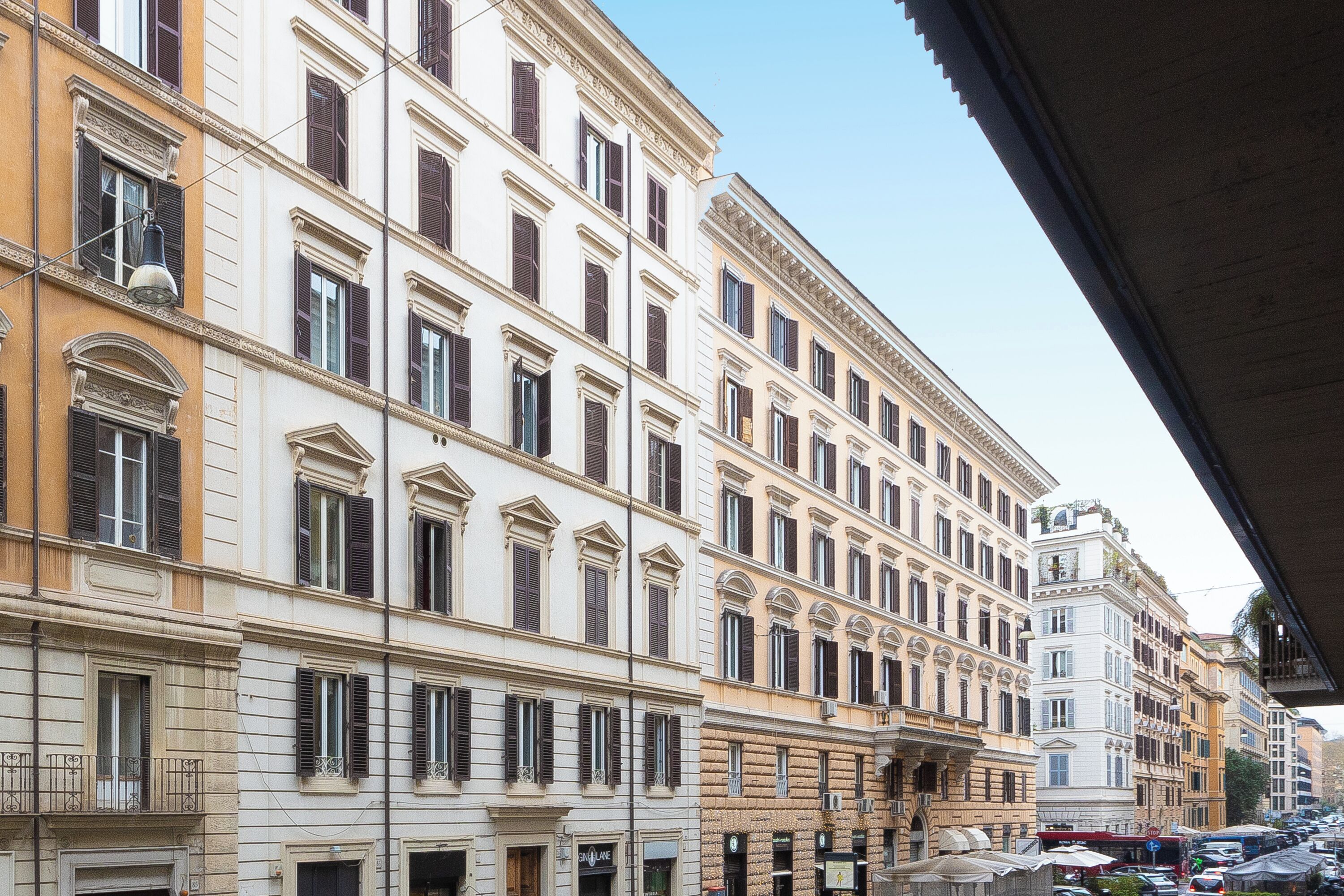 A row of historic buildings with uniform window designs and balconies.