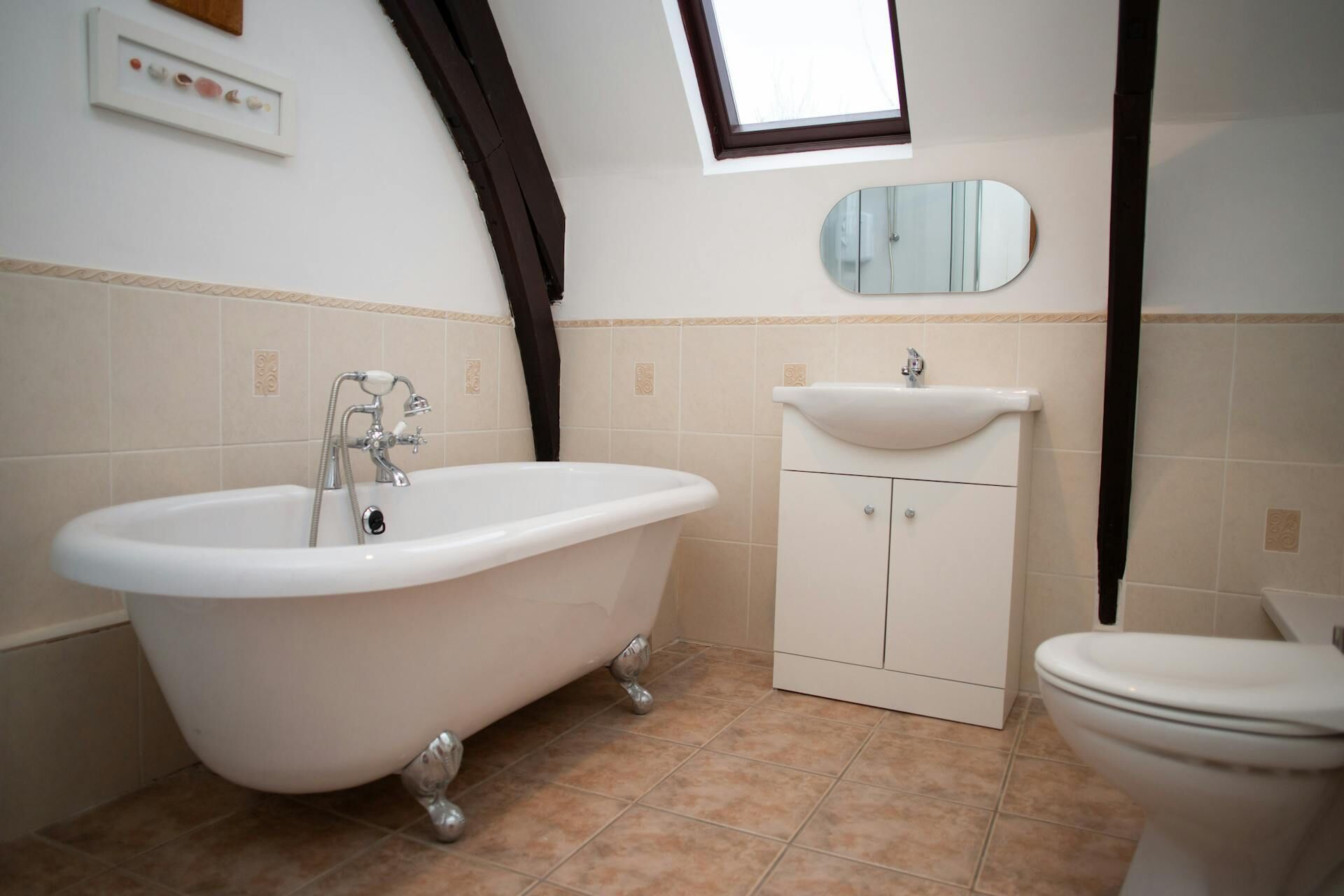 A bathroom with a freestanding bathtub, a sink, and a toilet.