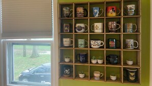 A room with a window and a shelf filled with mugs. - FIFA Coming to America! Minutes to MetLife Stadium & NYC ACTION! LET’S GO! (Emerson)