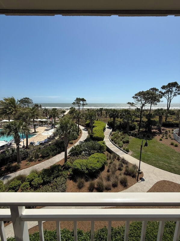 A resort with a pool, landscaped garden, and ocean view.