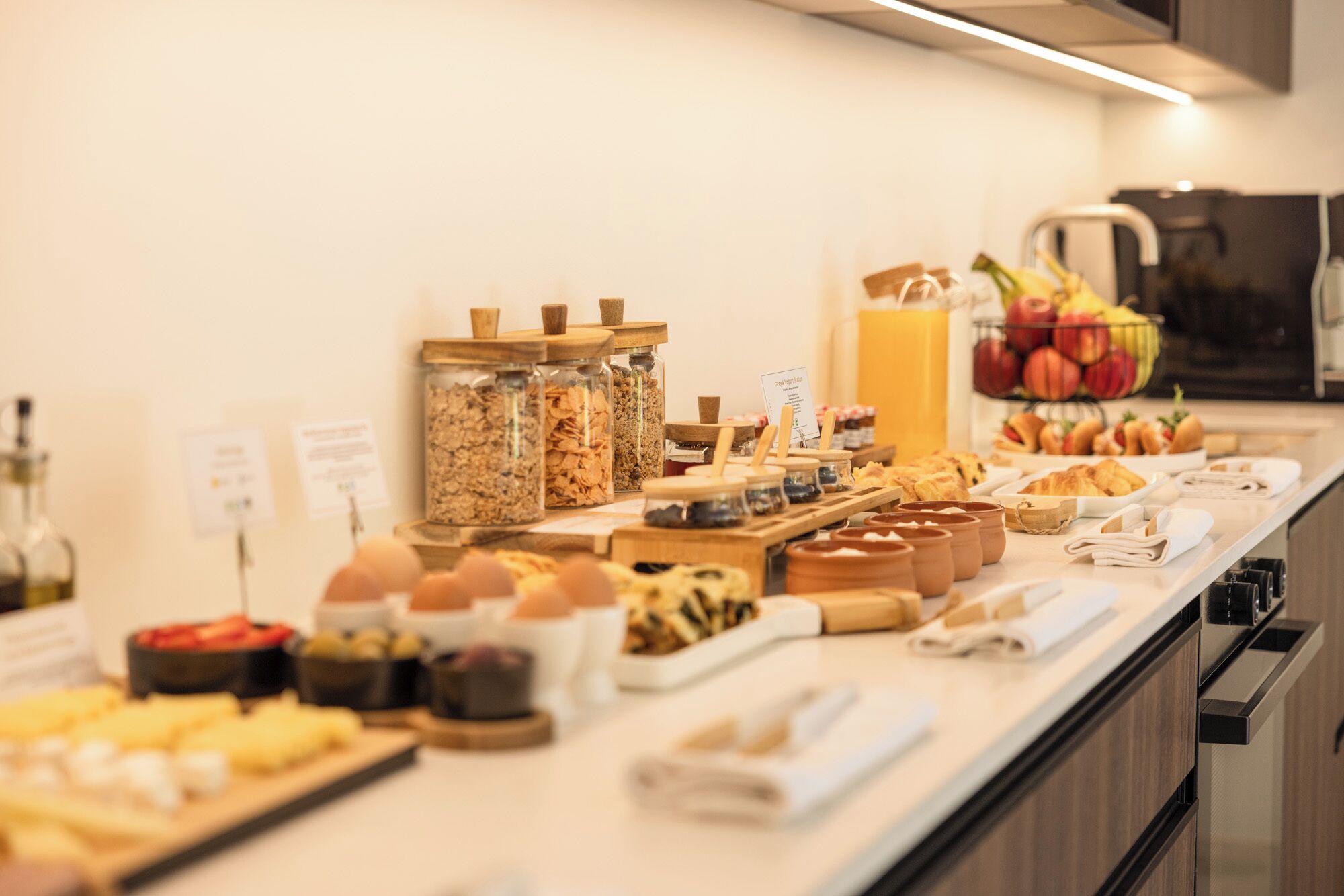 A breakfast buffet with various food items and condiments.